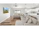 Comfortable living space with laminate wood flooring, large sectional sofa and flat screen TV with outdoor view at 9 Walnut Run, Ocala, FL 34480