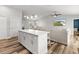 Open floor plan showcases a kitchen island, seamlessly connecting to the living area with vaulted ceiling at 9 Walnut Run, Ocala, FL 34480