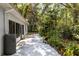 Exterior patio and lush backyard create a private outdoor retreat, perfect for relaxation and entertaining at 9565 Sw 194Th Cir, Dunnellon, FL 34432