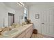 Well-lit bathroom with dual sinks, vanity, and ample counter space at 9565 Sw 194Th Cir, Dunnellon, FL 34432