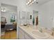 Bathroom featuring a double sink vanity area, bright lighting, and ample space at 9565 Sw 194Th Cir, Dunnellon, FL 34432