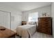 Cozy bedroom with natural light, a large dresser, and ample closet space, creating a serene atmosphere at 9565 Sw 194Th Cir, Dunnellon, FL 34432
