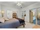 Inviting bedroom with hardwood floors, a ceiling fan, and access to an outdoor space at 9565 Sw 194Th Cir, Dunnellon, FL 34432