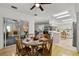 Bright dining area with wooden table and chairs, seamlessly connecting to the kitchen and outdoor space at 9565 Sw 194Th Cir, Dunnellon, FL 34432