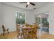 Cozy dining area with natural light, showcasing a wooden table and views of the outdoors at 9565 Sw 194Th Cir, Dunnellon, FL 34432