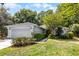 Charming single-story home with a well-manicured lawn, lush landscaping, and an attached two-car garage at 9565 Sw 194Th Cir, Dunnellon, FL 34432