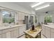 Bright, modern kitchen with stainless steel refrigerator, dishwasher, and a breakfast nook in the background at 9565 Sw 194Th Cir, Dunnellon, FL 34432