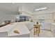 Spacious kitchen featuring white cabinets, ample counter space, and a view of the adjacent living room at 9565 Sw 194Th Cir, Dunnellon, FL 34432
