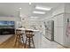 Modern kitchen with stainless steel appliances, a breakfast bar, and open access to the living area at 9565 Sw 194Th Cir, Dunnellon, FL 34432