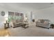 Cozy living room with stylish sofas, ample natural light, and an open view to the screened-in patio at 9565 Sw 194Th Cir, Dunnellon, FL 34432
