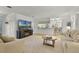 Bright open-concept living area with a modern fireplace, neutral decor, and seamless flow to the kitchen at 9565 Sw 194Th Cir, Dunnellon, FL 34432