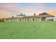 Large horse barn featuring multiple stalls and covered runs on a green lawn at Lot 8,9,10 Ne 155Th Pl, Citra, FL 32113