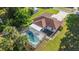 Aerial view of a house with a screened-in pool, well-maintained lawn, and a carport offering a private outdoor space at 10140 Sw 81St Terrace Rd, Ocala, FL 34481