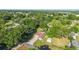 An aerial view of a well-maintained home with a screened pool and a detached garage surrounded by lush greenery at 10140 Sw 81St Terrace Rd, Ocala, FL 34481