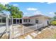 Home's backyard showcases a white picket fence, screened-in pool, and stepping stones leading to the house at 10140 Sw 81St Terrace Rd, Ocala, FL 34481