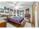 This cozy bedroom features a ceiling fan, wood floors and train decor at 10140 Sw 81St Terrace Rd, Ocala, FL 34481
