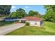 Inviting single-story home featuring a carport, well-kept lawn, and landscaping with a charming and appealing facade at 10140 Sw 81St Terrace Rd, Ocala, FL 34481
