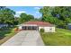Charming single-story home with a covered front porch, long driveway, and well-maintained lawn at 10140 Sw 81St Terrace Rd, Ocala, FL 34481