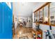 Inviting foyer with hardwood floors, view to living room, and a bright blue front door at 10140 Sw 81St Terrace Rd, Ocala, FL 34481