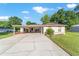 Charming single-story home with a covered carport, lovely landscaping and a paved driveway at 10140 Sw 81St Terrace Rd, Ocala, FL 34481