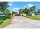 Charming single-story home with a long driveway, covered carport and manicured lawn at 10140 Sw 81St Terrace Rd, Ocala, FL 34481