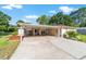 Single-story home with a covered carport, well-maintained landscaping and an attached garage at 10140 Sw 81St Terrace Rd, Ocala, FL 34481