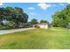 Manicured front lawn and long driveway leading to the covered carport of this charming home at 10140 Sw 81St Terrace Rd, Ocala, FL 34481
