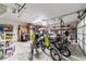 Spacious garage with concrete floor and storage shelves, housing two adult tricycles and ample storage opportunities at 10140 Sw 81St Terrace Rd, Ocala, FL 34481