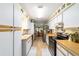 Galley kitchen with white cabinets and butcher block countertops at 10140 Sw 81St Terrace Rd, Ocala, FL 34481