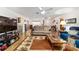 Spacious living room with wood flooring, comfortable seating, and a view to the foyer, creating an inviting atmosphere at 10140 Sw 81St Terrace Rd, Ocala, FL 34481