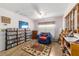 View of living room includes bookcases and chair and window to allow natural light at 10140 Sw 81St Terrace Rd, Ocala, FL 34481