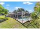 Backyard view of a screened-in pool and covered lanai, providing a private outdoor retreat at 10140 Sw 81St Terrace Rd, Ocala, FL 34481