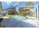 Inviting in-ground pool with a screened enclosure and a relaxing spa area at 10140 Sw 81St Terrace Rd, Ocala, FL 34481