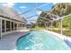 Clean in-ground pool features surrounding white screening to keep debris out for ease of maintenance at 10140 Sw 81St Terrace Rd, Ocala, FL 34481