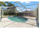 This screened-in pool features a unique shape and attached spa, offering the ultimate in relaxation and leisure at 10140 Sw 81St Terrace Rd, Ocala, FL 34481