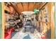 Organized shed featuring a lawn mower, gardening tools, and various storage shelves for outdoor equipment at 10140 Sw 81St Terrace Rd, Ocala, FL 34481