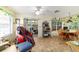 Bright sun room features tile flooring, a ceiling fan and dining area near sliding glass door to lanai at 10140 Sw 81St Terrace Rd, Ocala, FL 34481