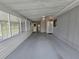 Large screened back porch with view of the door to laundry room at 10330 Sw 99Th Ave, Ocala, FL 34481