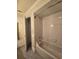 Bathroom with a white tiled shower and tile flooring at 10330 Sw 99Th Ave, Ocala, FL 34481