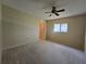 Carpeted bedroom featuring a ceiling fan and a window at 10330 Sw 99Th Ave, Ocala, FL 34481
