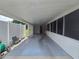 Large carport with view of yard, garden hose, and white fencing at 10330 Sw 99Th Ave, Ocala, FL 34481