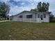 Charming single-story home with a carport, gray exterior, and a well-maintained front yard at 10330 Sw 99Th Ave, Ocala, FL 34481
