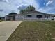 Charming single-story home with a carport, gray exterior, and a well-maintained front yard at 10330 Sw 99Th Ave, Ocala, FL 34481