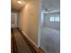Hallway with wood flooring that transitions to carpet, leading to bedrooms at 10330 Sw 99Th Ave, Ocala, FL 34481