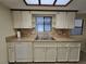 Kitchen area with double sinks and tile backsplash at 10330 Sw 99Th Ave, Ocala, FL 34481