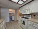 Charming kitchen featuring white appliances and ample cabinet storage, a perfect culinary space at 10330 Sw 99Th Ave, Ocala, FL 34481