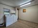 Bright laundry room with washer, dryer, and overhead cabinets offering convenience and storage at 10330 Sw 99Th Ave, Ocala, FL 34481