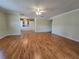 Open-concept living space with hardwood floors, neutral walls, and built-in cabinets at 10330 Sw 99Th Ave, Ocala, FL 34481
