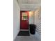 Welcoming back patio entrance with a red door and covered space, ideal for relaxing outdoors at 10330 Sw 99Th Ave, Ocala, FL 34481
