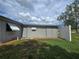 Side view of house, shows storage area, rear of house, awnings, and a privacy fence at 10330 Sw 99Th Ave, Ocala, FL 34481